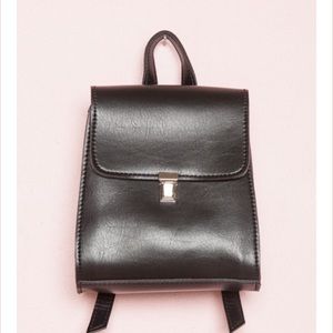Silver buckle black backpack